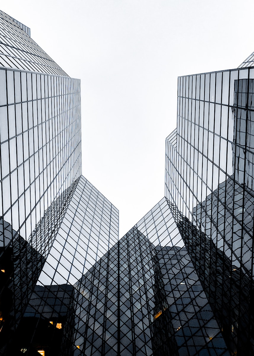 Glass buildings as viewed from the ground in daylight.